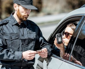 Policeman giving breathalyzer BAC test